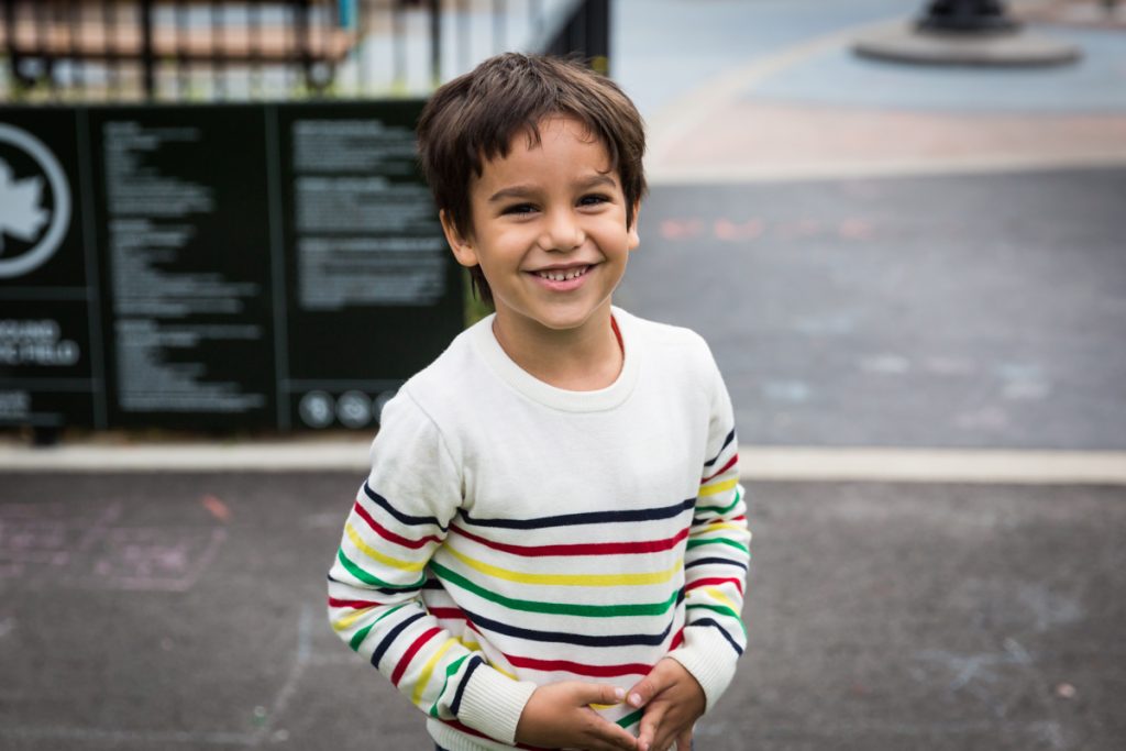 Boy wearing colored strip shirt at an Ennis Playground family portrait session