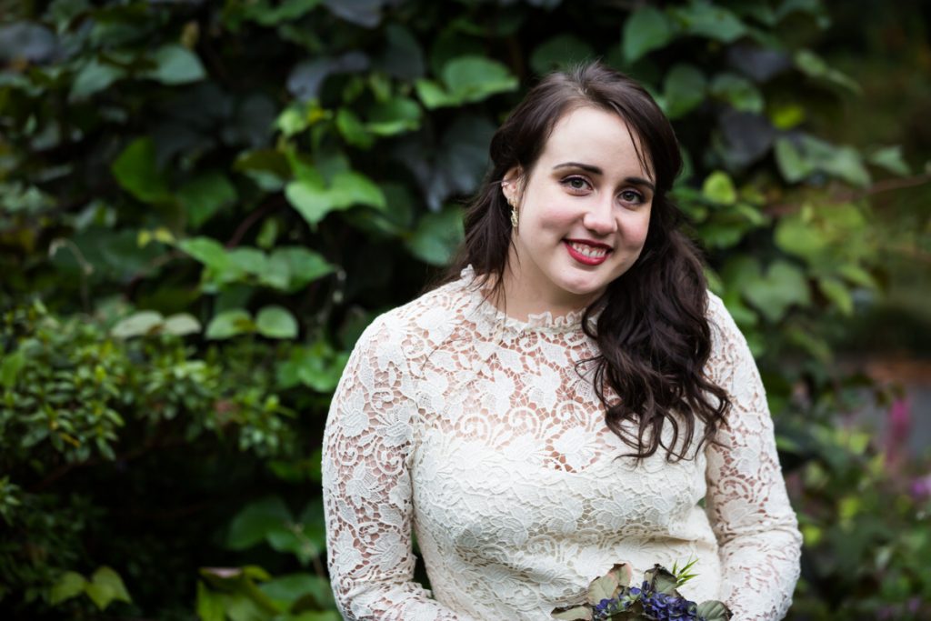 Portrait of bride in front of green bush in Fort Tryon Park