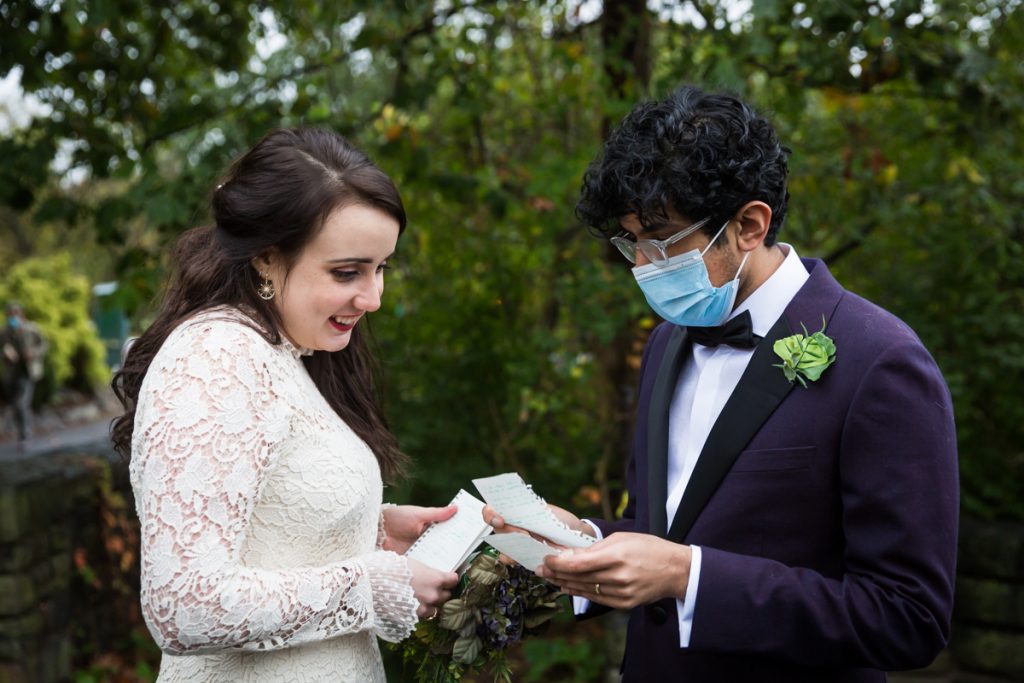 Couple checking personal vow notes before Fort Tryon Park wedding ceremony
