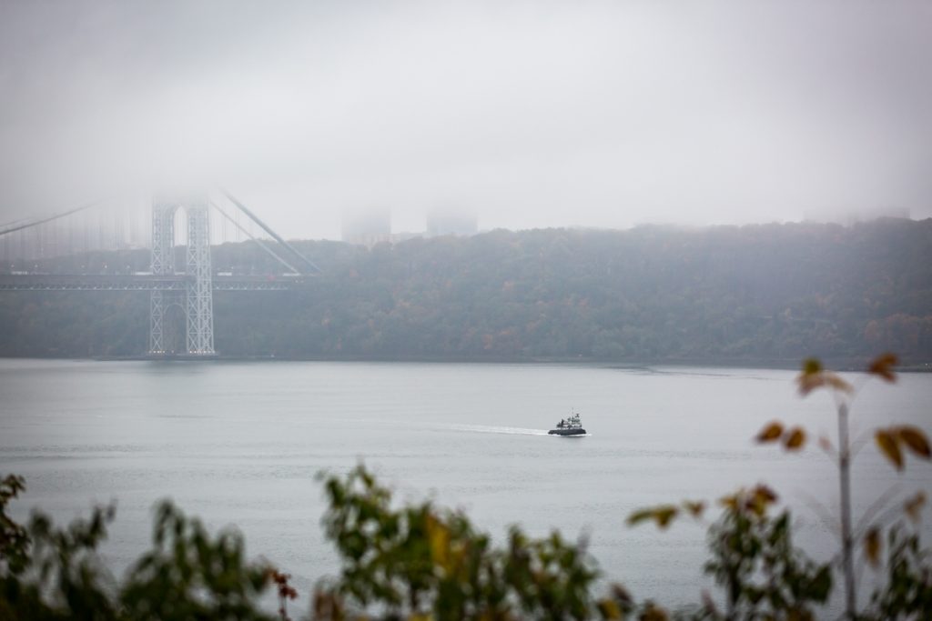 View of George Washington bridge and boat in Hudson River