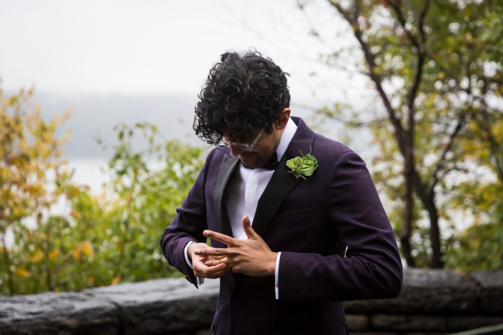 Groom struggling to put on wedding ring during Fort Tryon Park wedding