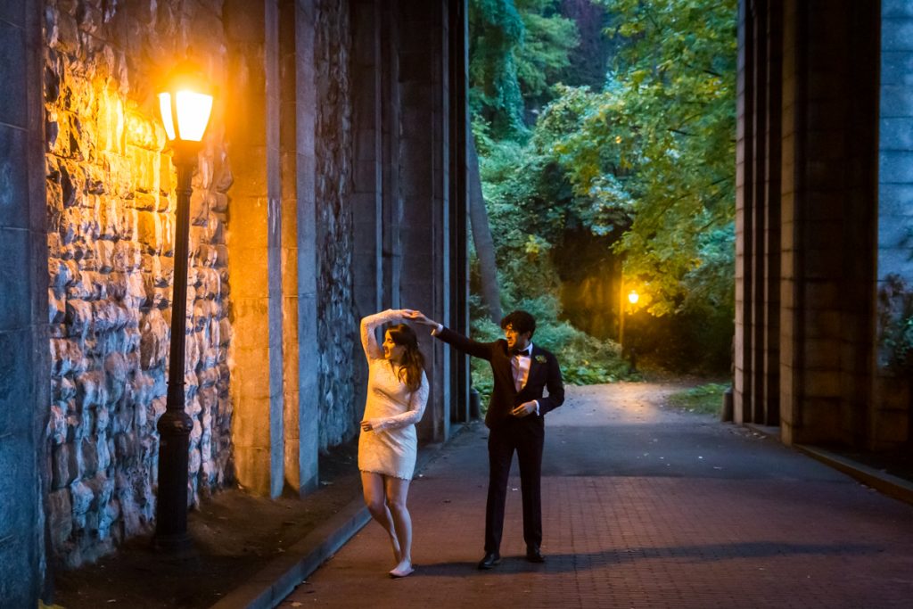 Couple dancing under lamp post in Billings Arcade in Fort Tryon Park