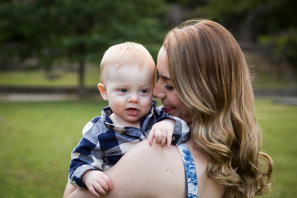 Mother snuggling with baby son over her shoulder during a Marcus Garvey Park family portrait session