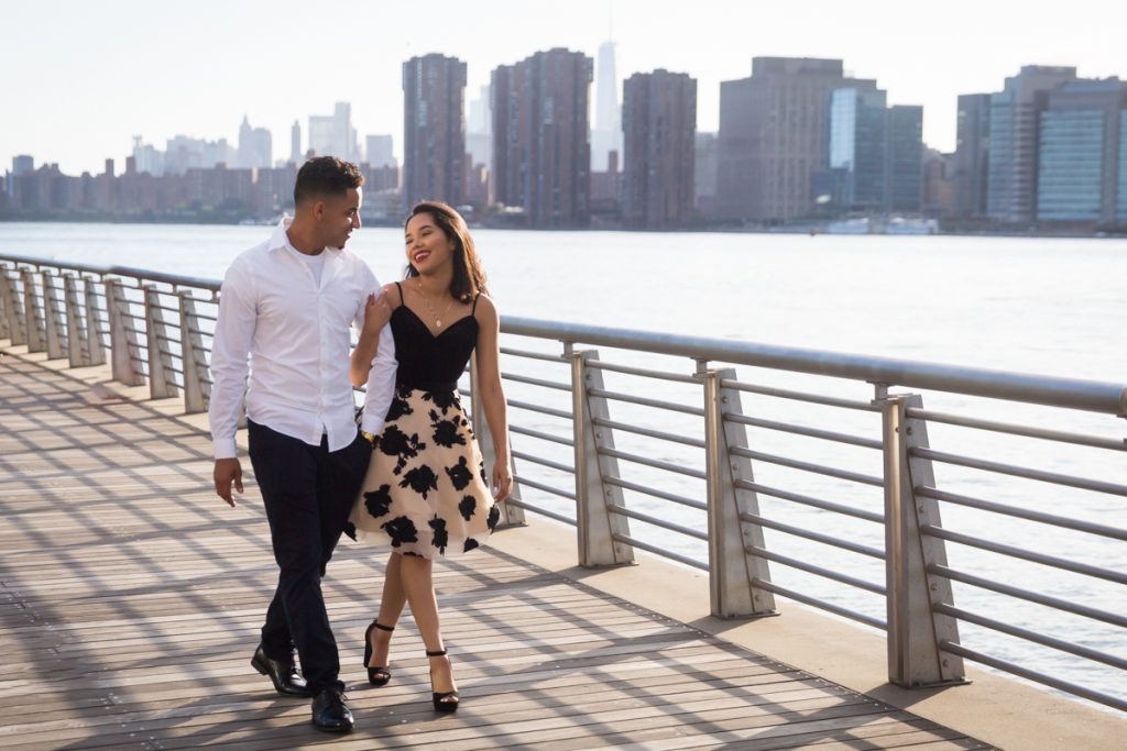 Couple walking along boardwalk at Gantry Plaza State Park for an article on photo shoot details to remember