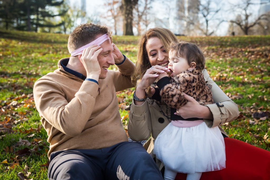 Father wearing little girl's headband for an article on Central Park holiday portrait tips