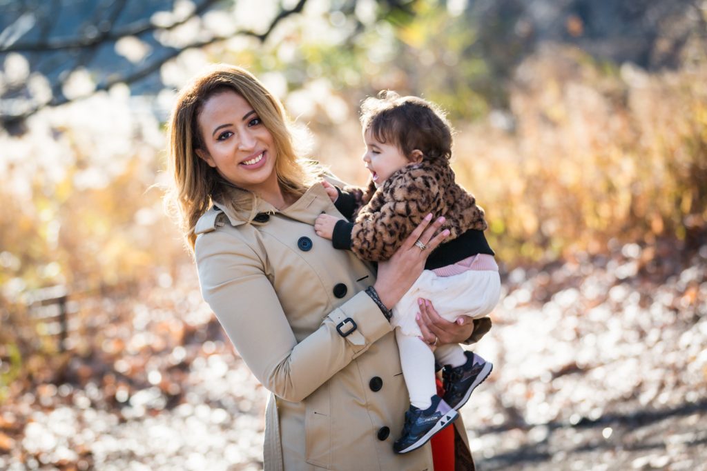 Mother holding little girl in Central Park