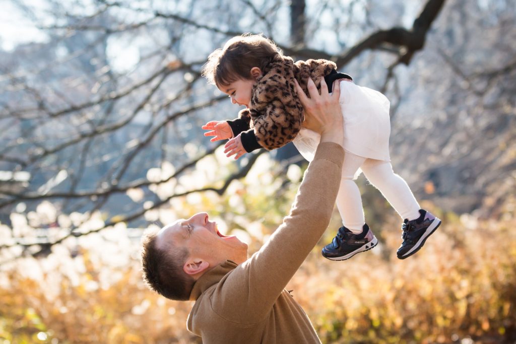 Father lifting up little girl in the air