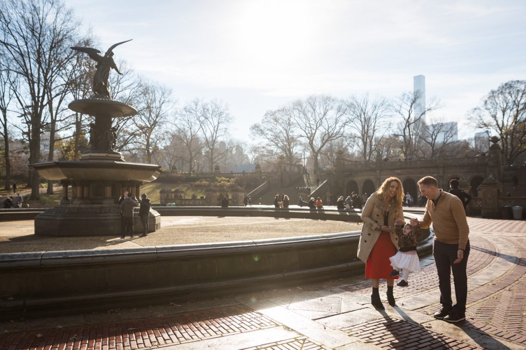 Parents and little girl beside Bethesda Fountain
