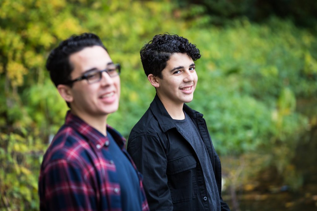 Two young men in front of Turtle Pond in Central Park