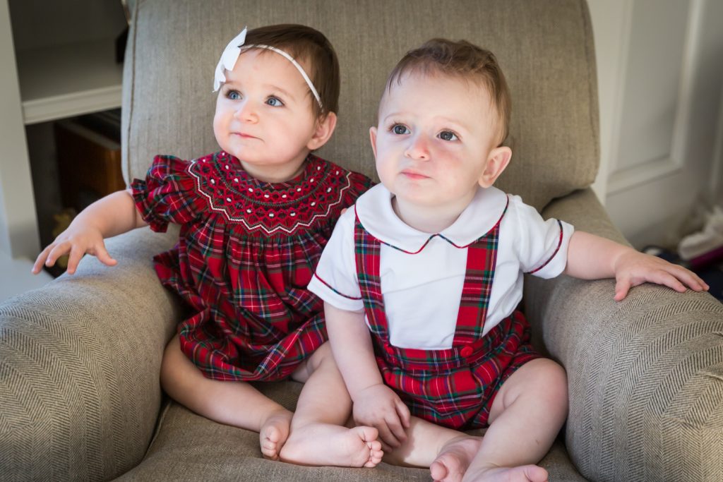 Twin babies sitting in a chair
