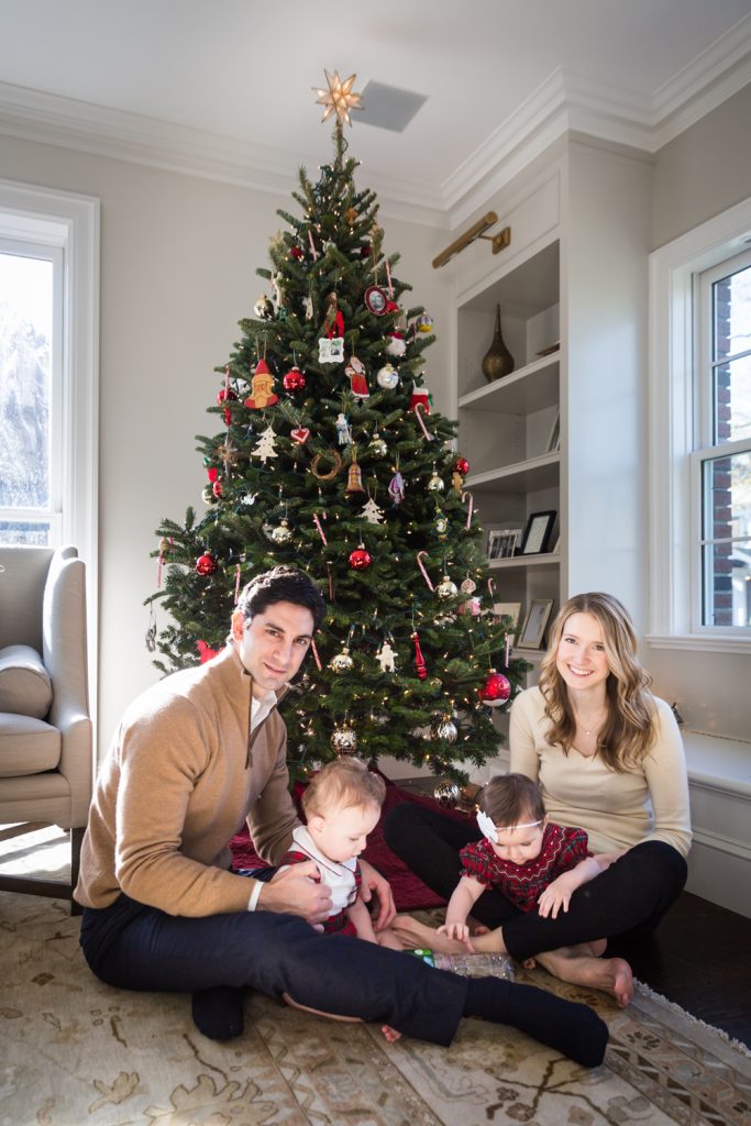Parents with twin babies in front of Christmas tree