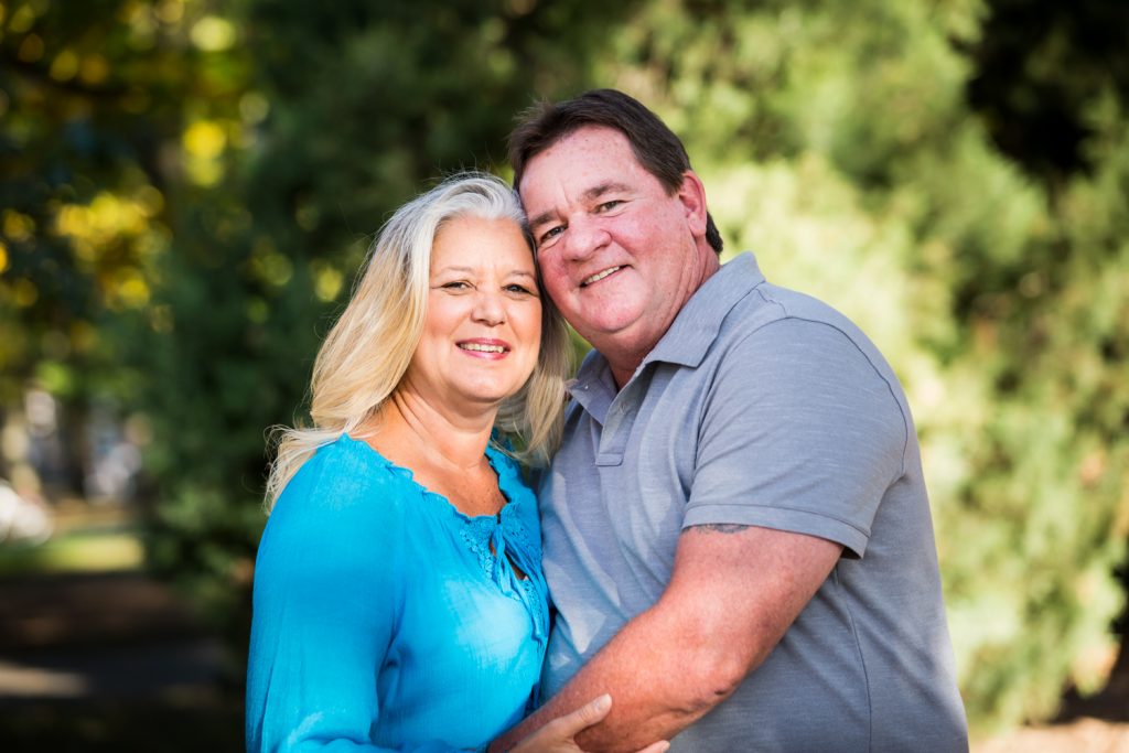 Couple hugging during a Juniper Valley Park family portrait session