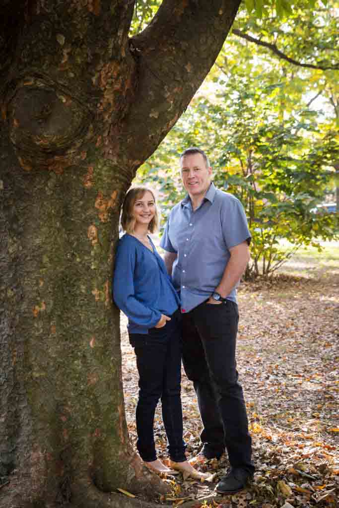 Couple leaning against tree in Juniper Valley Park