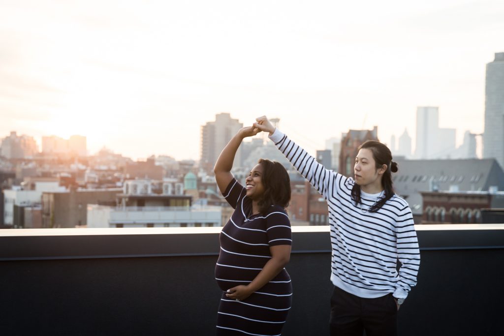 Couple dancing on a roof for an article on indoor maternity photo shoot tips