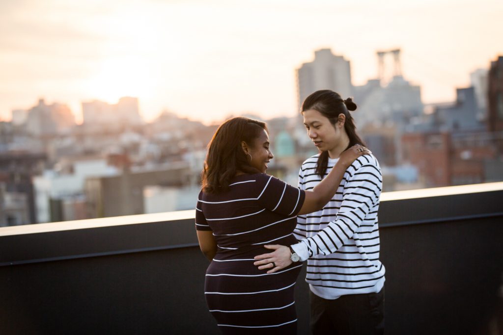 Couple dancing on roof during maternity portrait photo shoot