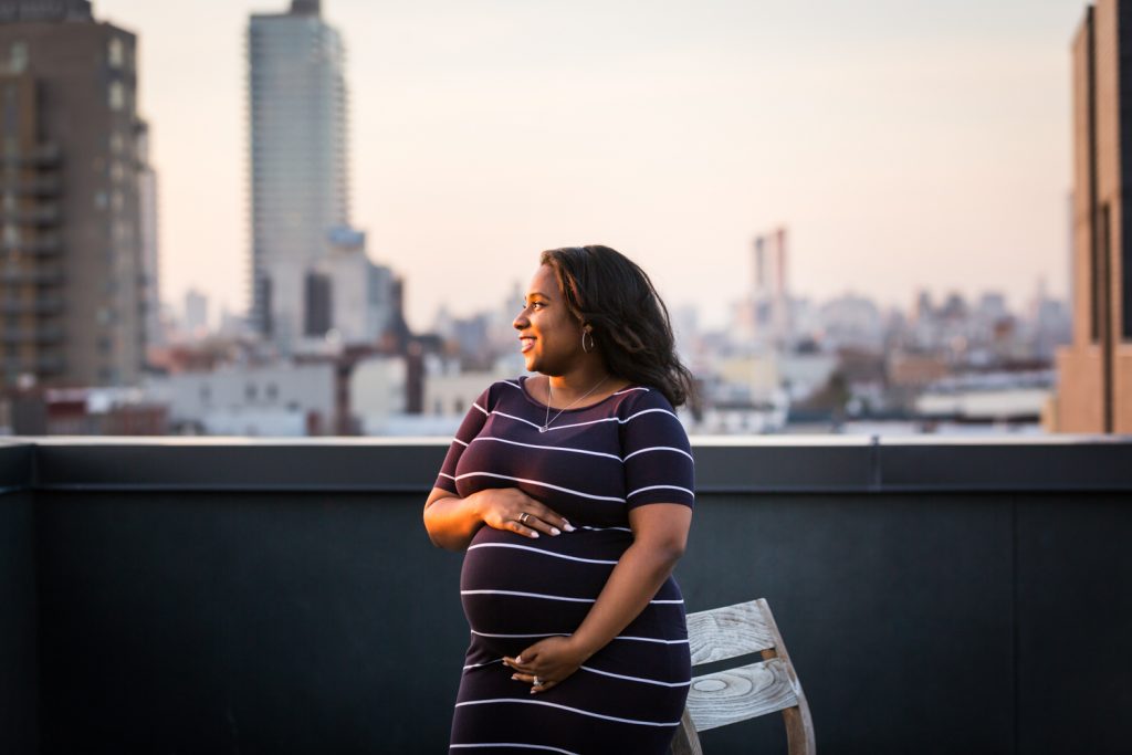 African American pregnant woman looking to side on rooftop