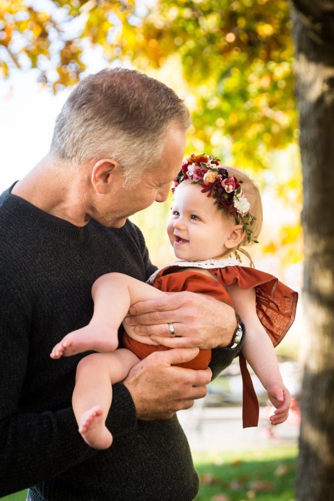 Father holding little girl for an article NYC golden hour portrait tips