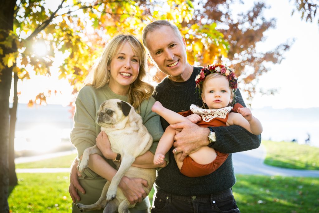 Parents with little girl and dog for an article NYC golden hour portrait tips