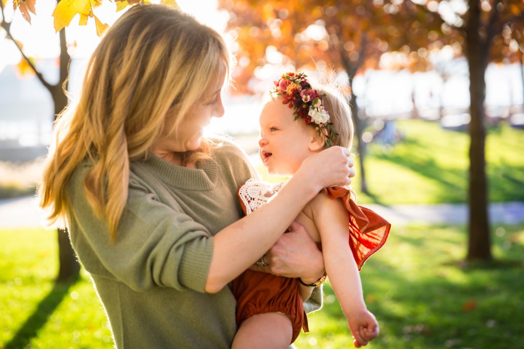 Mother holding baby girl for an article NYC golden hour portrait tips