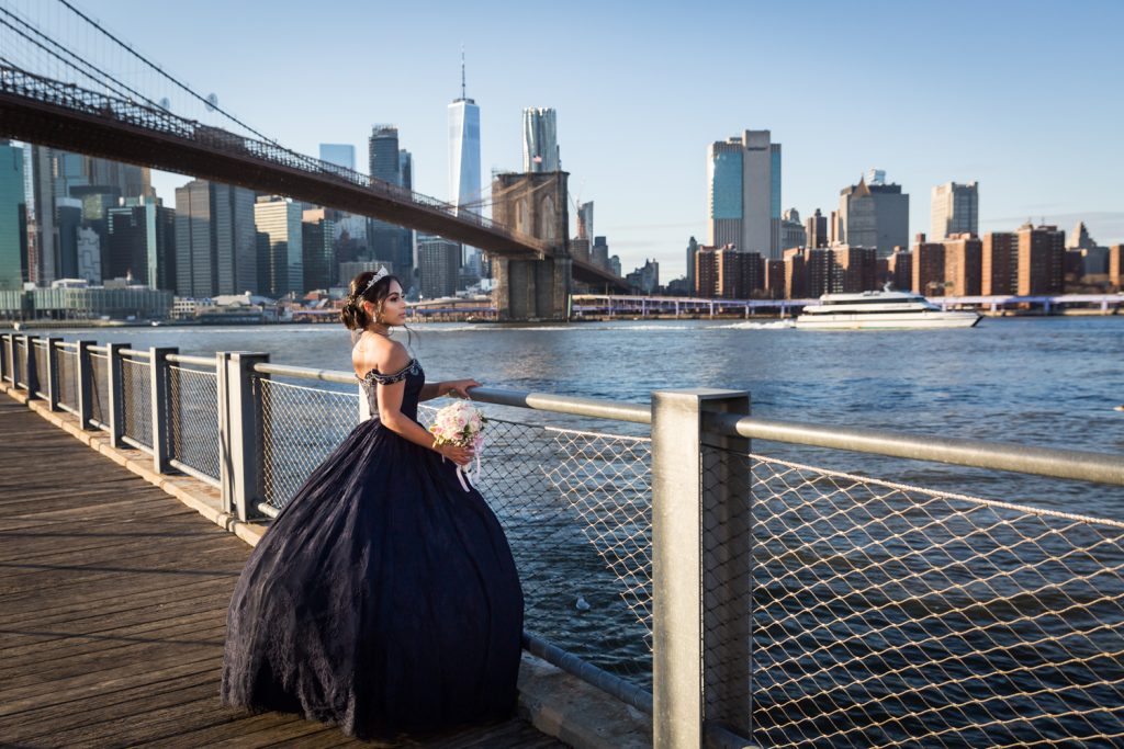Girl wearing navy ball gown looking at East River