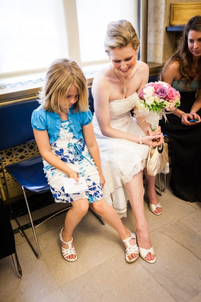 Comparing shoes before a NYC City Hall wedding, by Kelly Williams