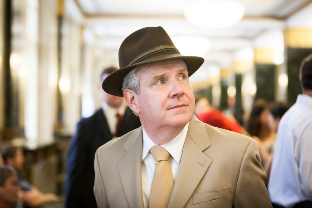 Dapper father of the bride in a fedora at a NYC City Hall wedding