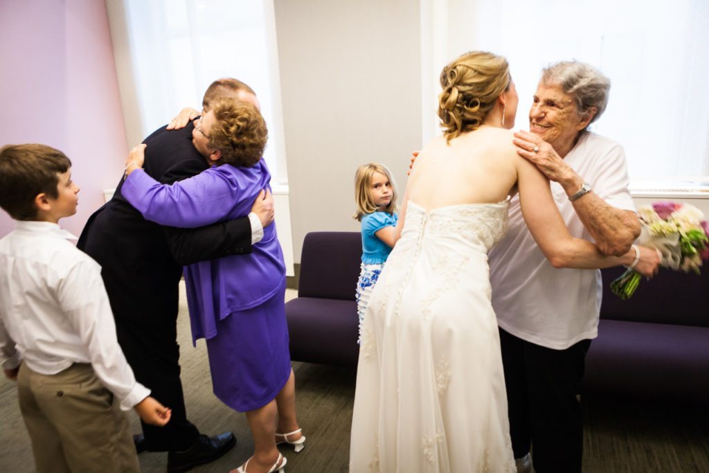 Hugging after a NYC City Hall wedding, by Kelly Williams