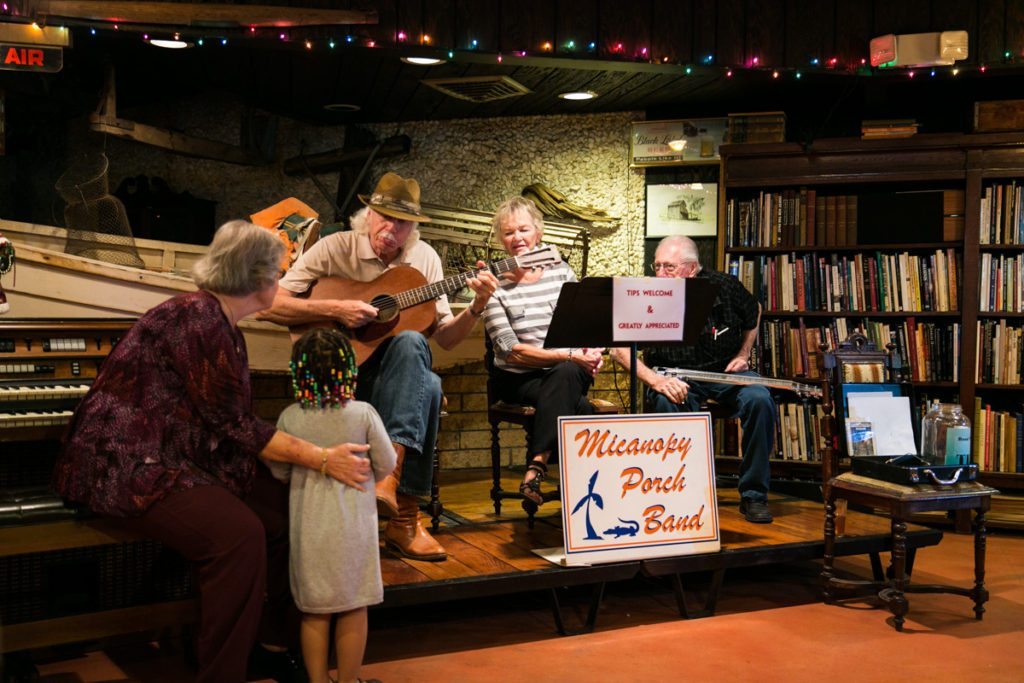 The Micanopy Porch Band entertaining a young fan at the Yearling Restaurant in Cross Creek