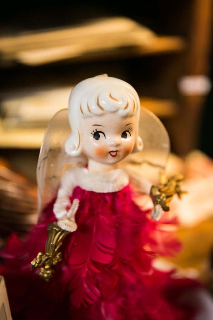 A kewpie doll angel for sale in an antiques store