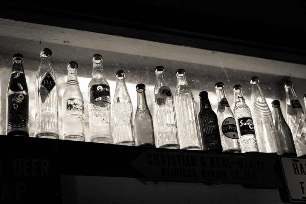Antique soda bottles on display in a cafe