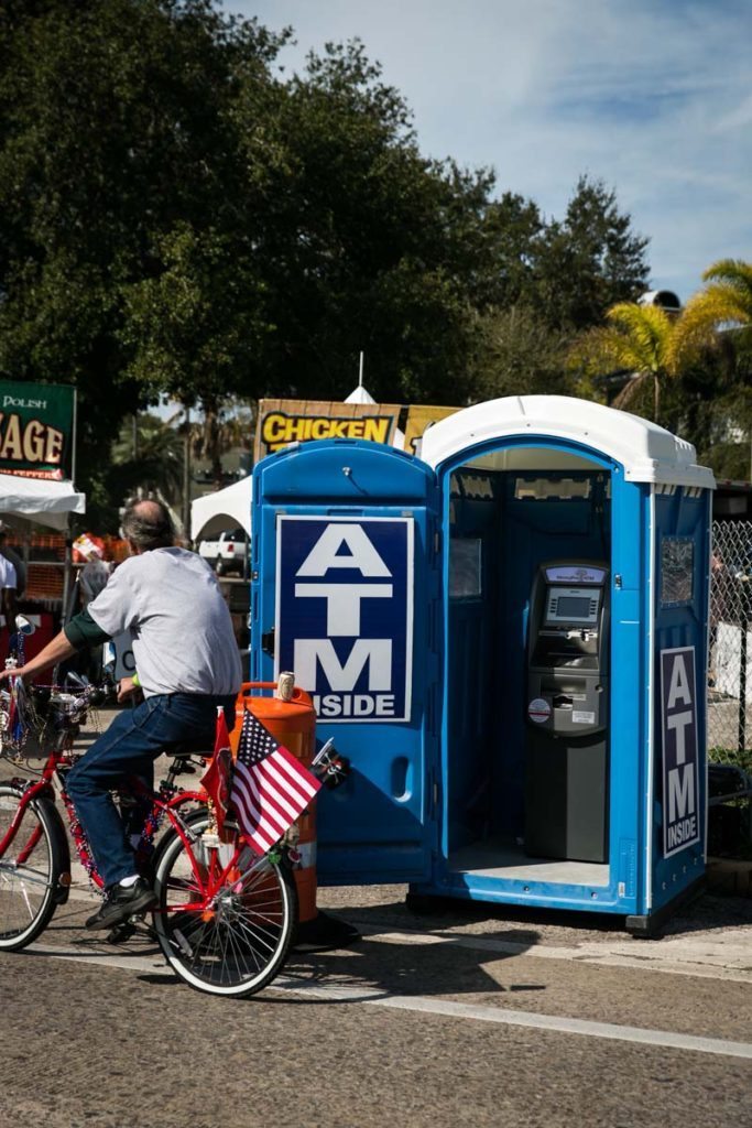An ATM conveniently located in a port-a-potty, by NYC photojouralist, Kelly Williams.