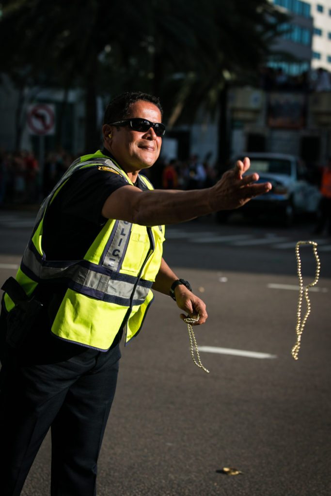 A friendly cop distributes beads, by NYC photojouralist, Kelly Williams.