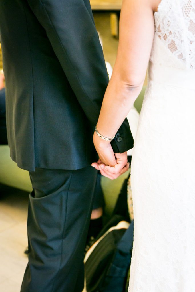 A couple holding hands, by NYC City Hall wedding photographer, Kelly Williams
