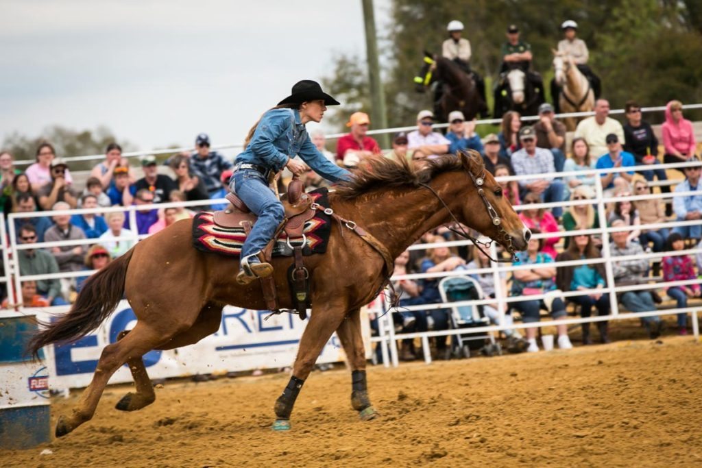Barrel racing at the county fair championship rodeo, by NYC photojournalist, Kelly Williams