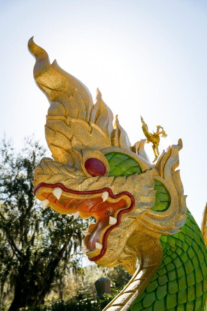 A dragon guards the exterior of the Wat Mongkolratanaram, photographed by NYC photojournalist, Kelly Williams