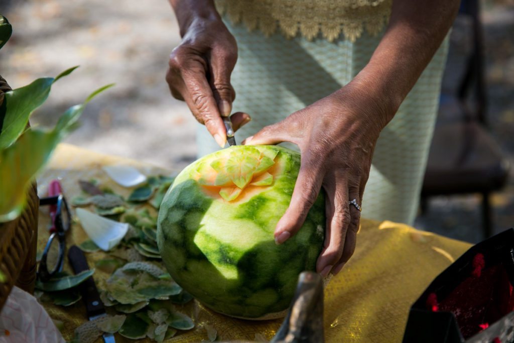 A demonstration of fruit carving at the Wat Mongkolratanaram, photographed by NYC photojournalist, Kelly Williams