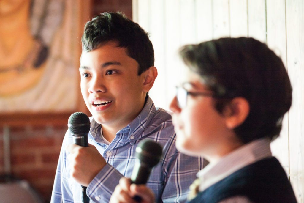 Kids performing karaoke, by NYC bat mitzvah photographer, Kelly Williams