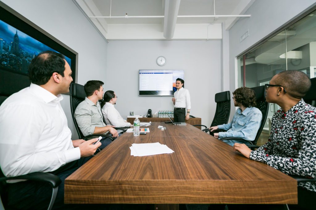 Conference room interaction shot for an office portrait tips article by NYC executive headshot photographer, Kelly Williams