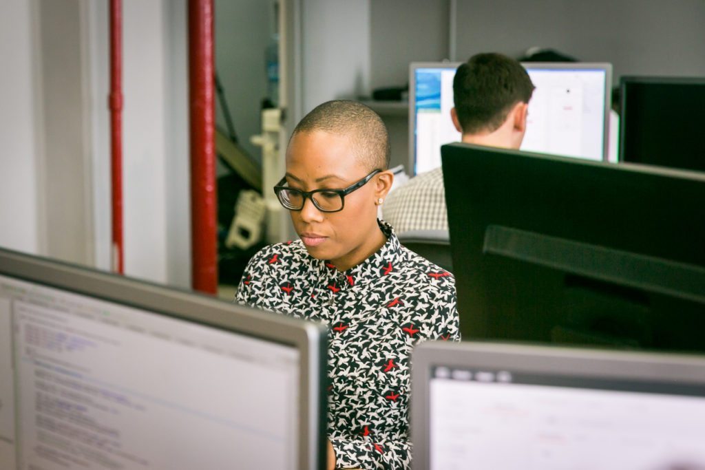 Office interaction shot for an office portrait tips article by NYC executive headshot photographer, Kelly Williams