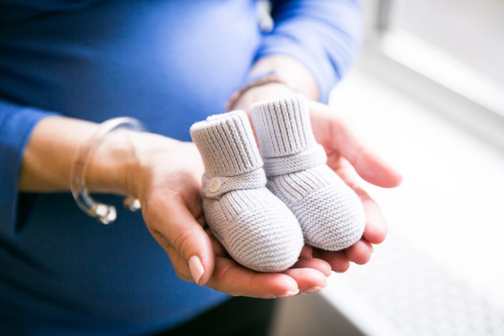 Baby booties by photojournalistic maternity photographer, Kelly Williams