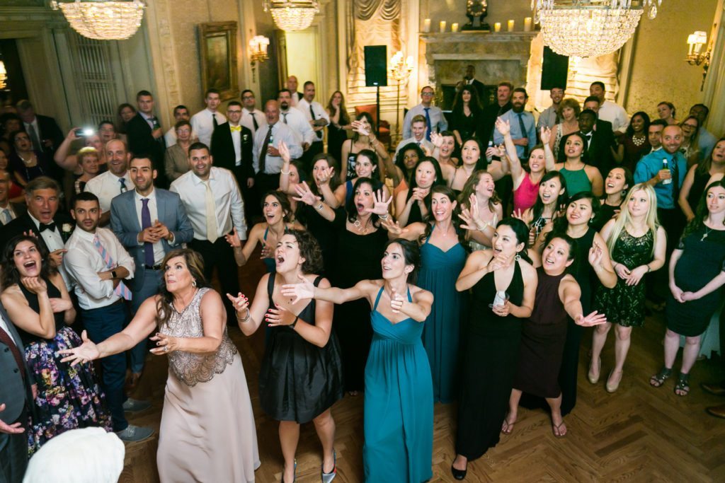 Bouquet toss at a Columbus Citizens Foundation wedding by NYC wedding photojournalist, Kelly Williams