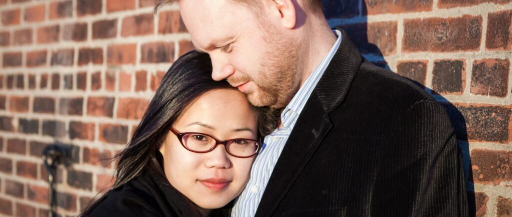 Red Hook engagement photos of couple against brick wall