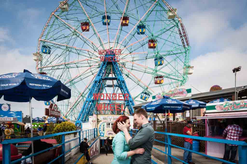 Coney Island engagement photos of couple in front of Wonder Wheel