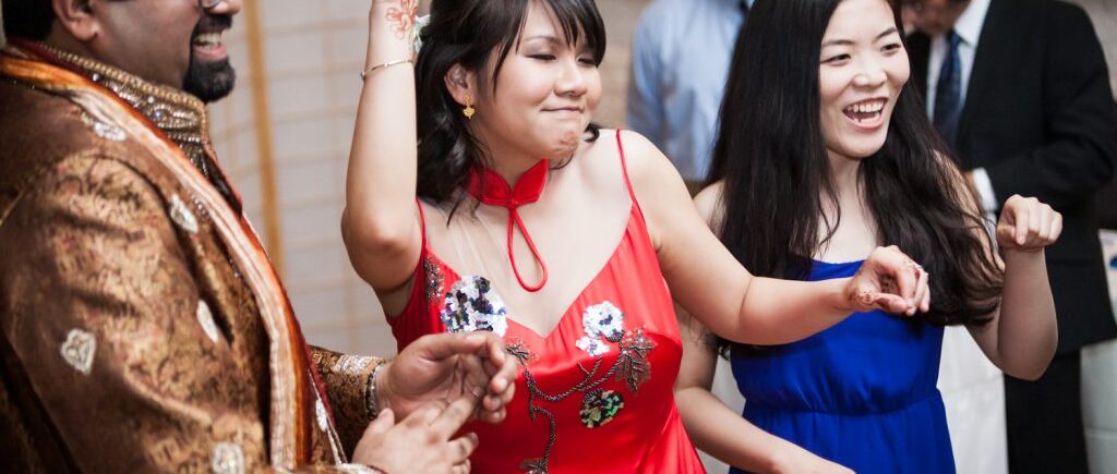 Bride in red qipao dancing at an Alger House wedding
