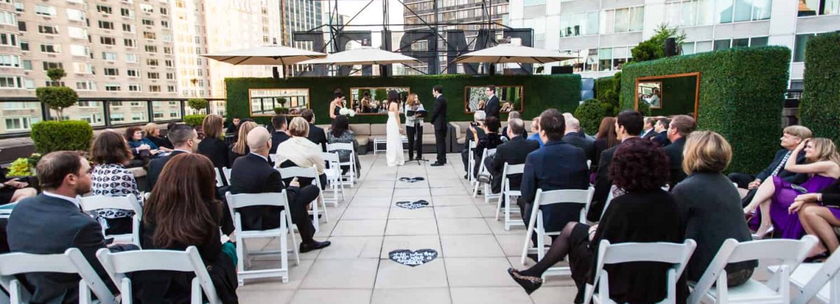 Wide shot of ceremony at an Empire Hotel rooftop wedding