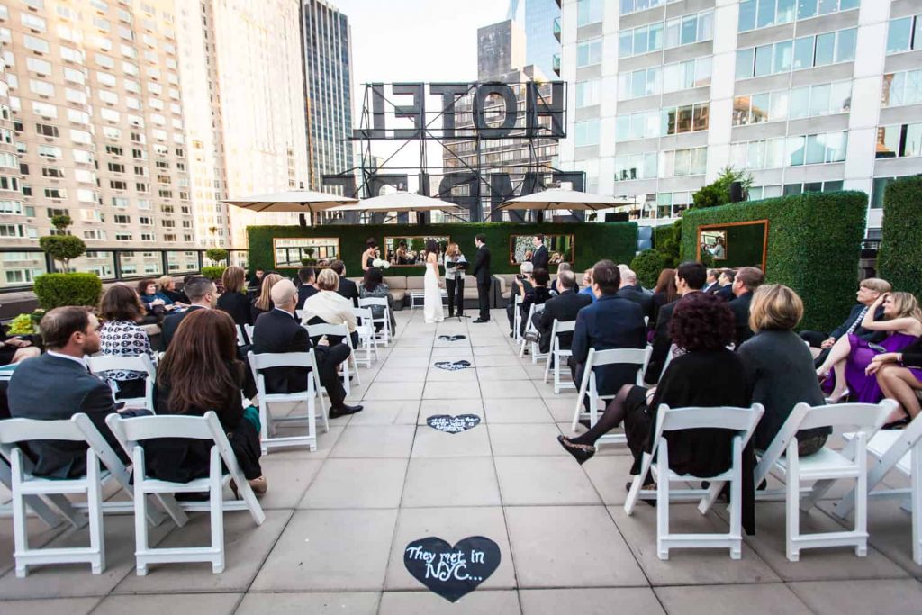 Wide shot of ceremony at an Empire Hotel rooftop wedding
