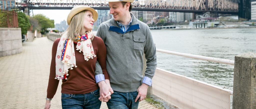 Couple walking hand-in-hand during a Roosevelt Island engagement portrait session