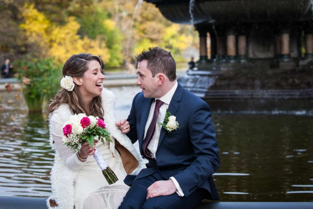 Bride and groom laughing at a Bethesda Fountain wedding in Central Park