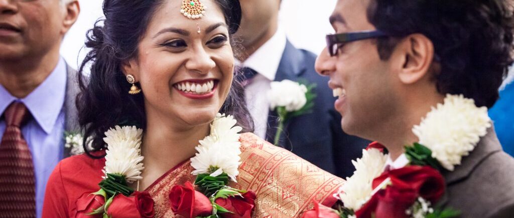 Indian bride and groom wearing traditional sari and flower garlands at a NYC City Hall Indian wedding