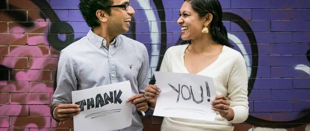 Thank you card photos of couple laughing and holding signs